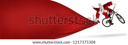 crazy santa claus jump on dirt mountain bike with big huge red bag copy space isolated white banner background