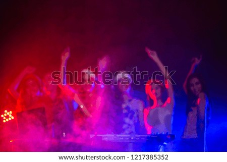 Abstract blurred Ecstatic dj and dancers