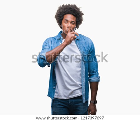 Afro american man over isolated background asking to be quiet with finger on lips. Silence and secret concept.