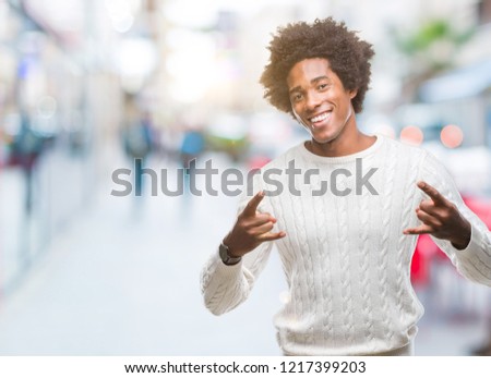 Afro american man over isolated background shouting with crazy expression doing rock symbol with hands up. Music star. Heavy concept.