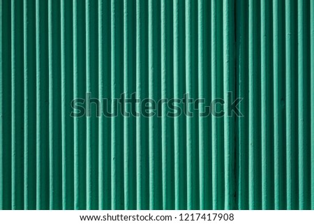 abstract green metal facade with shadowplay