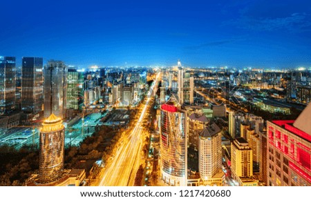 High-rise buildings and viaducts in the financial district of the city, night view of Beijing, China.