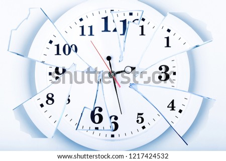 clock with broken glass on a white background. chaos time. time passing concept. Royalty-Free Stock Photo #1217424532