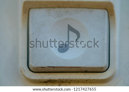 Blurred old electronic doorbell at entrance door of apartment