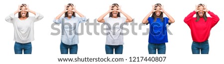 Composition of chinese asian woman over isolated background doing ok gesture like binoculars sticking tongue out, eyes looking through fingers. Crazy expression.