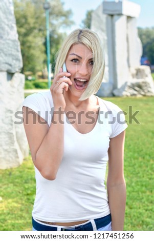 Beautiful happy surprised women in the park outdoors on grass