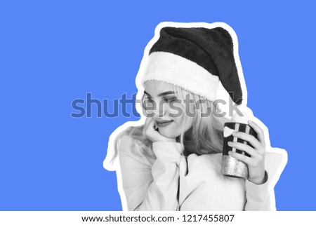 Attractive smiling young girl dressed in Santa's hat holds the colorful mug and pillow and dreams about gifts. Christmas and New Year advertising concept. Magazine style fashion collage