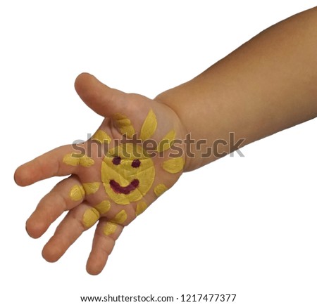 children's hand with the smiley painted on it