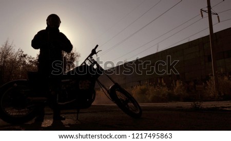 Motorbiker silhouette on the road