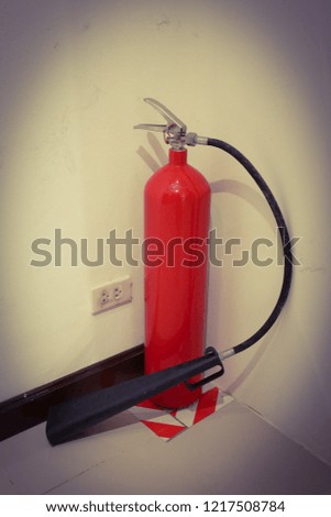 A red fire extinguisher is located at the corner of the room.


