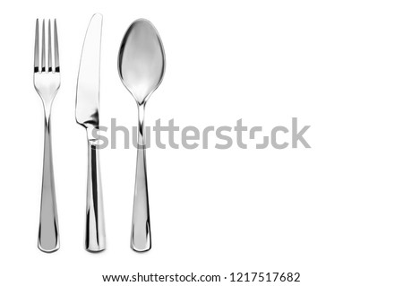 A top down view on a cutlery in white background Royalty-Free Stock Photo #1217517682