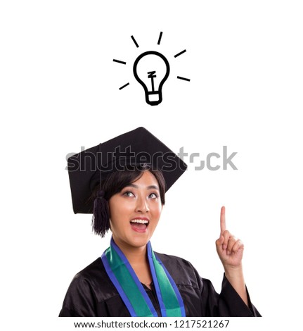 A-ha! Cheerful young Asian female student in academic dress, feel excited to find an inspiration, illustrated with glowing lightbulb cartoon on top of her head, portrait isolated over white background