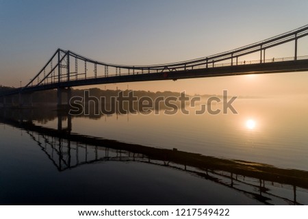 Sunrise aerial view of pedestrian Park bridge, left bank of Kyiv and Dnipro river in the morning from above in  Kyiv, Ukraine