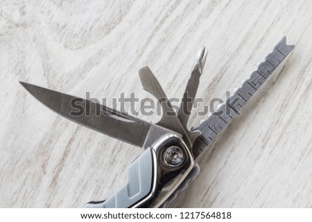 Stainless steel multi-tool on white background