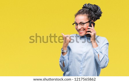 Young braided hair african american business girl showing calling using smartphone over isolated background happy with big smile doing ok sign, thumb up with fingers, excellent sign