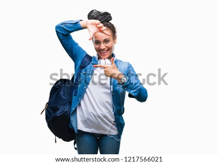 Young braided hair african american student girl wearing backpack over isolated background smiling making frame with hands and fingers with happy face. Creativity and photography concept.
