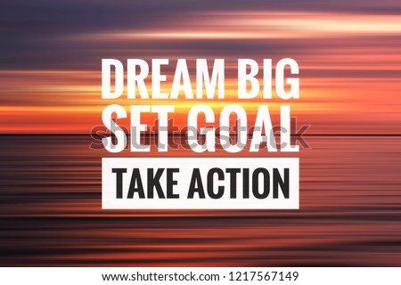 Inspirational motivation quote on the abstract sunset background. Dream big set goal and take action. 
