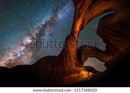 Milky Way Galaxy behind Double Arch sandstone rock formation in Arches, National Park, Utah Royalty-Free Stock Photo #1217588020