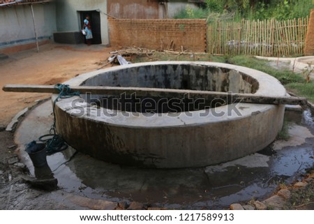Indian Village Water Well with rope and steel bucket   Royalty-Free Stock Photo #1217589913