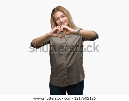 Young caucasian business woman over isolated background smiling in love showing heart symbol and shape with hands. Romantic concept.