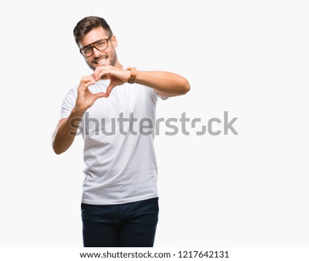 Young handsome man wearing glasses over isolated background smiling in love showing heart symbol and shape with hands. Romantic concept.