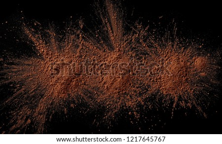 pile cocoa powder isolated on black background, top view