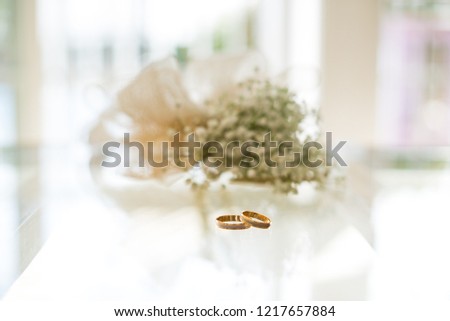 Pretty gold rings of the bride and groom for the wedding