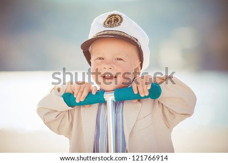 Little boy playing outdoor on the pier