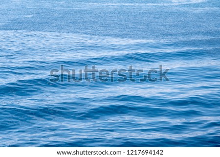 Blue sea water with ripples surface. Rippled water texture. Breezy seaside landscape. Fresh clean water texture. Blue ocean view. Relaxing summer vacation photo wallpaper