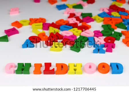The word childhood with colored letters