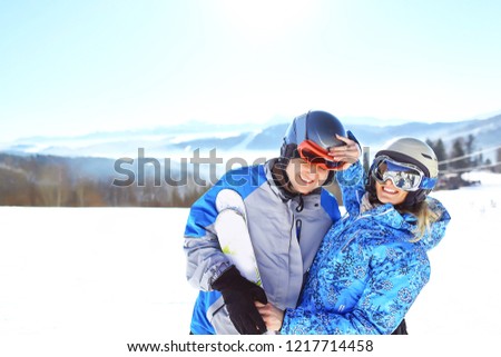 Cheerful couple having fun at top of ski slope. selective focus.