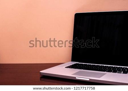 desktop with PC computer. mock up working place. light from outside. loft cement wall background. clipping path included
