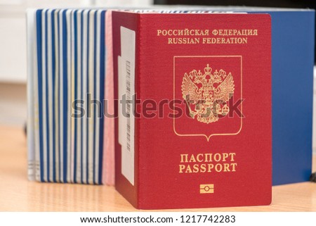 Russian biometric passport against other documents during border control. Inscription - Russian Federation. Passport. Close-up