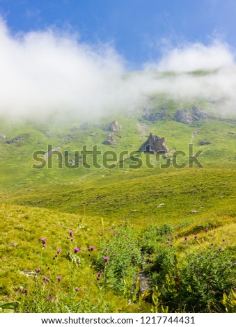 Beautiful green mountains during summer with peaks covered by clouds