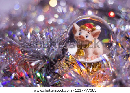 Christmas, new-year symbol 2019 pig in a ball, tinsel, glitter, lights, garland, bokeh.