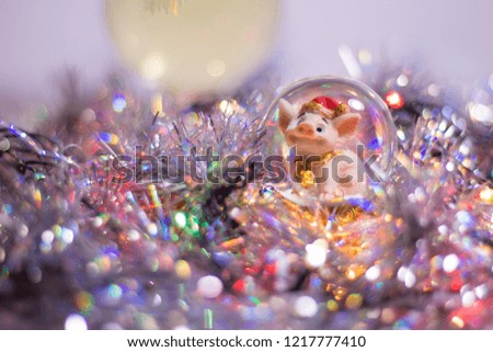 Christmas, new-year symbol 2019 pig in a ball, tinsel, glitter, lights, garland, bokeh.