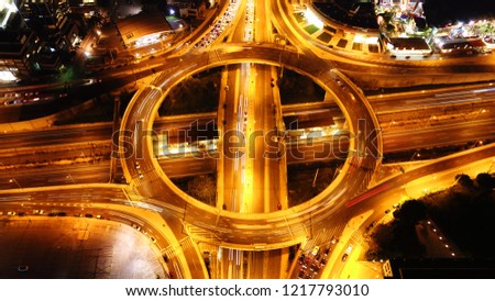 Aerial drone high speed night shot of urban elevated toll ring road junction and interchange overpass