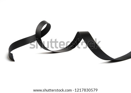 beautiful black ribbon twist spiral isolated on white background Royalty-Free Stock Photo #1217830579