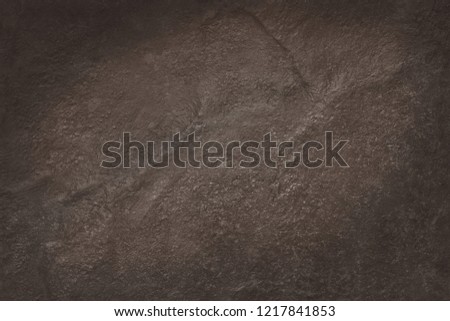Dark brown slate texture in natural pattern with high resolution for background and design art work. Brown stone wall.