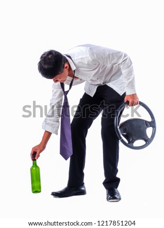 Drink don't drive concepts.Drunk Asian business man wear white shirt holding wine bottle and steering wheel on  isolated white background