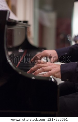 Hands playing piano in recording studio close up