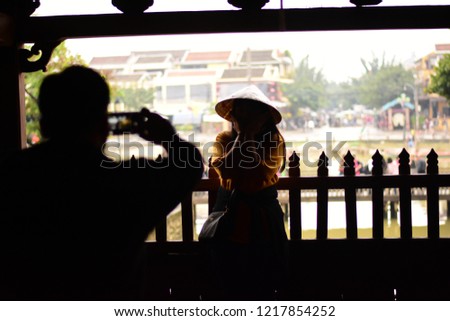 Inside the Japanese Covered Bridge, Hoi An, Vietnam, UNESCO, World Heritage Site. Taking photo tourists silhouette.