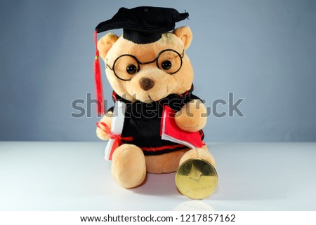 A picture of graduation bear and Etherum coin. Education industry will use crypto currency in the future. 