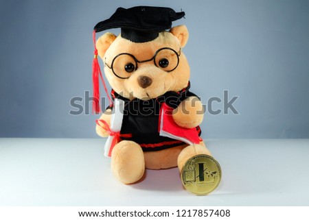A picture of graduation bear and Lite coin. Education industry will use crypto currency in the future. 