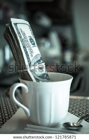 Money in a coffee cup, financial business concept