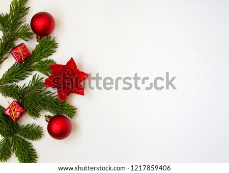 christmas frame with pine branches balls and red flower
