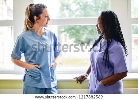 Nurses having a conversation in the hospital hallway Royalty-Free Stock Photo #1217882569