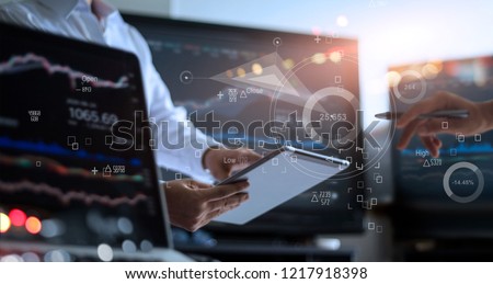 Business team working together. Businessman analyzing data stock market in monitoring room on the data presented in the chart, forex trading graph, stock exchange trading online, financial investment 