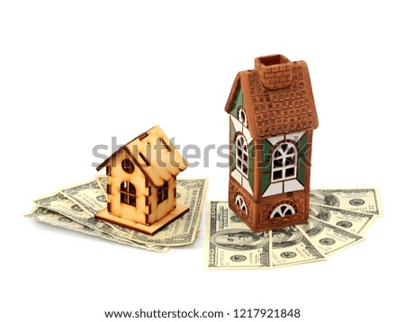 wooden and clay houses on paper notes American dollars as a symbol of financial market volatility