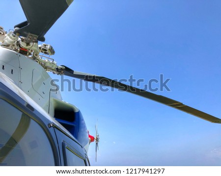 Helicopter main rotor or The rotor of helicopter. civilian helicopter rotor blade detail close up. swashplate of a helicopter under blue sky with a space or background for inspirational quote or text.